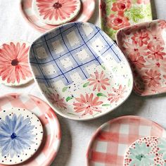 several plates and bowls with flowers painted on them