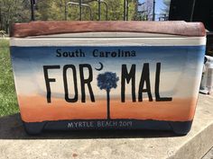 a blue and orange painted ice chest with the name of south carolina formal written on it