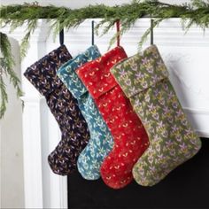 three christmas stockings hanging from a mantel