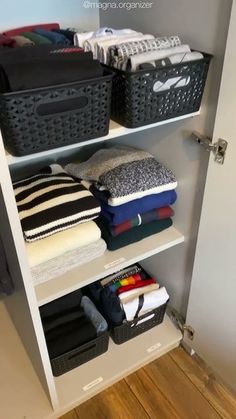 an organized closet with baskets and blankets