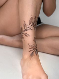 a woman's leg with a tattoo on it and her bare foot in the foreground