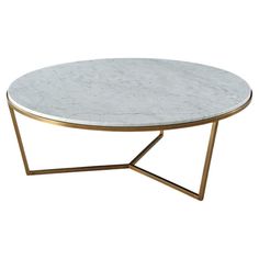 a white marble coffee table with gold metal legs and an oval top, on a white background