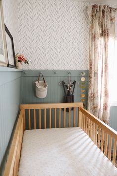 a baby's crib in the corner of a room