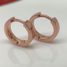 14 gauge hoop earrings hand crafted from sterling silver and plated in rose gold. Sold as a single earring or as a pair. Also available in 20 gauge normal ear posts. SPECIFICATION Base metal: Recyclable fine 925 Sterling Silver Decorative outer plating: rose gold Inner diameter: 13mm, size L Width: 3.5mm Ear post gauge: 14 gauge Measurements are an approximation Dainty Rose Gold Hoop Jewelry, Dainty Rose Gold Tarnish-resistant Huggie Earrings, Rose Gold Sterling Silver Huggie Earrings, Adjustable Nickel Free Rose Gold Hoop Earrings, Silver Hoop Jewelry In Copper, Silver Hoop Jewelry Made Of Copper, Rose Gold Tarnish-resistant Dainty Huggie Earrings, Silver Copper Hoop Jewelry, Silver-colored Copper Hoop Jewelry