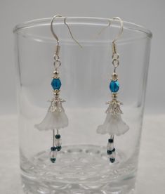 These delicate flower earrings are  a pretty , lightweight  accessory that you can wear with your every day attire that would also make a great gift for mom. A fantastic boho look for women of any age.  Made with delicate opaque white bell flower beads,  3 & 4 mm fire polished beads, silver daisy spacer beads, bead caps and seed beads hung from ear wires. Earring measures approximately 2 inches long total. Ready to ship.   Attention! Colors may look different depending on your monitor settings. Teal Flowers, Great Gifts For Mom, Flower Beads, Boho Look, Delicate Flower, Bead Caps, Beaded Flowers, Flower Earrings, Spacer Beads