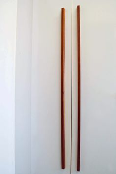 two wooden sticks sticking out of the wall