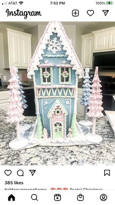 a gingerbread house is decorated with pink and blue icing