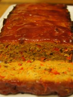 a loaf of meatloaf with carrots and sauce