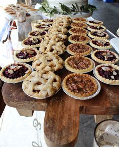 many pies are lined up on a table