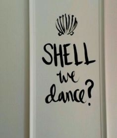 a sign that says shell we dance? on the side of a refrigerator freezer