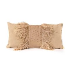 a beige pillow with feathers on the front and back, sitting against a white background