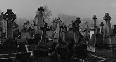 an old cemetery with many headstones and crosses