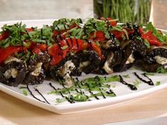 a white plate topped with mushrooms covered in toppings