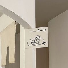 there is a sign that says order hanging on the wall next to an open door