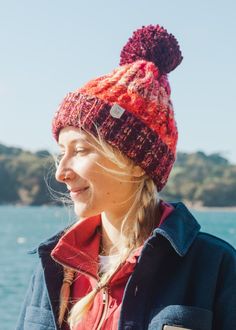 Oh Hey 'Explorers' This one's for you! Our multi yarn twisted cable knitted hat is perfect for keeping you cosy on all your adventures. Lined with a fleecy faux Shearling thermal band for extra snugness it will keep you toasty warm in any weather. Finished with an UltraLeather vegan friendly tag. Our vegan 'leather' tags are hand sewn in our studio using all natural yarn. With our 'Land + Sea' logo on one side and Junkbox Apparel wordmark on the reverse. BSCI & Reach certified. Luxury bobble Fau Red Winter Hat For Outdoor, Warm Red Hat For Outdoor, Warm Red Outdoor Hat, Red Warm Outdoor Hat, Winter Yarn Hats For Outdoor, Winter Outdoor Yarn Beanie, Yarn Winter Hats For Outdoor Use, Sea Logo, Yarn Twist