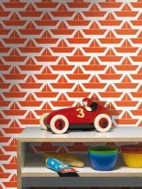 a red toy car sitting on top of a wooden shelf next to bowls and plates