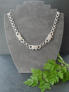 "A beautiful hallmarked sterling silver link necklace, hand made in chainmaille.  Individual jump rings have been carefully woven together to make 3 'kisses', each flanked by mobius 'hugs', in the centre of the necklace, which are separated by double layered links.  Each kiss has a quartet of twisted silver links in the centre, adding a little texture.  The link chain is then continued at each side but graduated towards the clasp, to make the necklace fit nicely around the neck.  It's very comfo Chainmaille Necklace, Silver Link Necklace, Hugs Kisses, Necklace Chain Lengths, Wedding Jewellery Necklace, Necklace Sterling Silver, Link Necklace, Silver Jewellery, Sterling Silver Necklace