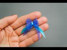 a small blue bow on someone's hand