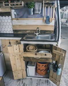 the kitchen is made out of pallet boards and has been built into an rv