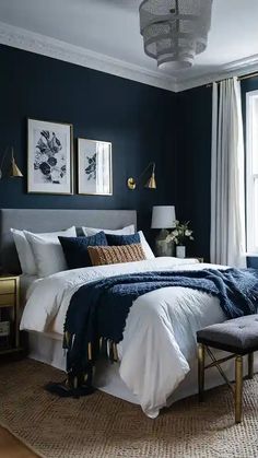 a bedroom with dark blue walls and white bedding