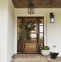 the front door is decorated with wreaths and flowers