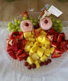 a platter with fruit and yogurt on it for a child's birthday