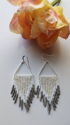 Our friend Amy recently had a birthday. I made these for Amy for her birthday. You now can also own a pair of these birthday earrings for yourself. This is exciting if you like these earrings. Amy won't mind that I put them on here to sell, because Amy is awesome and super sweet. As you can see, they are lovely neutral colors. Woven onto a silver triangle, finished with sterling silver ear wires. Made to order. Not available for wholesale. Adjustable White Beaded Earrings With Silver Beads, Nickel-free White Beaded Earrings, White Silver Beaded Drop Earrings, White Nickel-free Beaded Earrings, White Bohemian Jewelry For Birthday, Bohemian White Jewelry For Birthday, Silver Beaded Earrings For Crafting, Handmade Dangle Earrings For Birthday, White Beaded Earrings As Gift