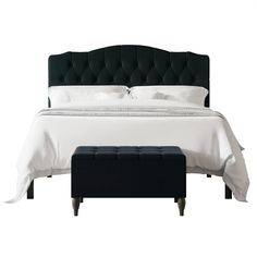 a bed with a black headboard and foot stool in front of it on a white background