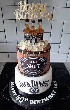 a birthday cake made to look like an old no 7 barrel with bottles on top