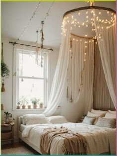 a bed with white curtains and lights hanging from the ceiling