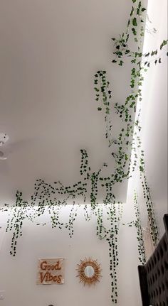 the ceiling is covered with vines and plants in an office space that has been painted white