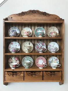 a wooden shelf filled with lots of plates