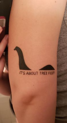 a woman with a tattoo on her arm that says it's about tree fed