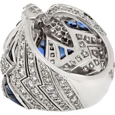 Immerse yourself in the world of luxury, where artistry and innovation converge in the Cartier 18K White Gold Diamond And Sapphire Dove Ring. This exquisite piece embodies elegance and grace, featuring a stunning dove motif crafted from 18K white gold, adorned with shimmering diamonds and vibrant sapphires. The intricate design captures the essence of love and freedom, making it a perfect symbol for cherished moments.Crafted by renowned designer Cartier, this ring is a testament to timeless beauty and exceptional craftsmanship. The diamonds and sapphires sparkle with every movement, creating a mesmerizing display of light and color. Whether worn as a statement piece or as a symbol of affection, this ring is sure to captivate hearts and turn heads wherever you go.Indulge in sophistication a Luxury Sapphire Diamond Ring With Diamond Cut, Luxury Sapphire Diamond Ring With 17 Jewels, Cartier Luxury White Gold Diamond Ring, Luxury Cartier White Gold Diamond Ring, Luxury Sapphire Ring With Diamond Cut Cubic Zirconia, Formal Cartier Rings With Pave Setting, Cartier Rings With Pave Setting For Formal Occasions, Luxury Diamond Cut Diamond Ring, Cartier Diamond Ring For Formal Occasions