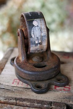 an old metal object with a little boy on it