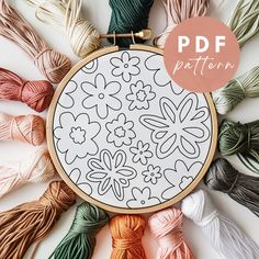 the embroidery pattern is surrounded by many different colored yarns