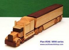 a wooden toy truck is shown on a table