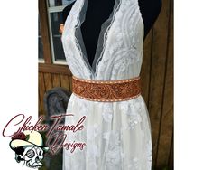 the dress is white and has brown trim