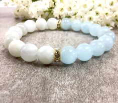 "✦Gemstone: Aquamarine and Moonstone ✦Color: Blue and Clear ✦Shape: Round  ✦Length: 5''-9'' ✦Bead Size: 10mm ✦QTY: 1 pcs / package ✦✦Please measure your wrist size, then order the bracelet. MEASURE YOUR WRIST:    - Measure around at the wrist bone in tape or even a strip of paper.   - Choose a place where you would normally wear a bracelet.  Make it as loose or snug.   - To use the strip of paper, mark where the end of the bracelet needs to be and then measure the paper with a ruler.   - Increase the wrist measurement in the following increments to determine the bracelet size for how you want the bracelet to fit.      Add about 1/4 to 1/2 inch for a loose fit. There are main moonstone powerful meanings. 1. It's considered a shining light 2. Helps you feel empowered when making decisions 3. Aquamarine Crystal Bracelet, Round Bead Bracelet Ideas, Healing Gemstone Bracelets, Bracelet Inspo, Reiki Jewelry, Bracelet Summer, Feel Empowered, Shining Light, Amazonite Bracelet