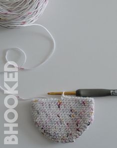 a crochet bag next to a knitting needle