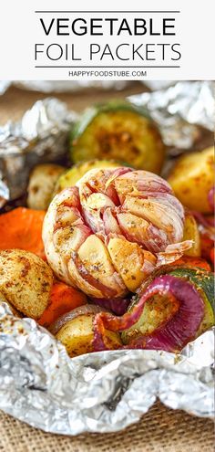 foil packets filled with vegetables on top of a wooden table and text overlay that reads, vegetable foil packets