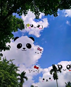 there are many pandas flying in the sky with their faces drawn on them,