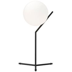 a white ball sitting on top of a metal pole next to a black stand with a light