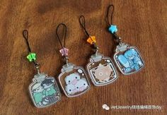 four tags with cartoon characters on them sitting on a wooden table next to each other