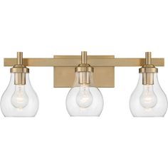 three light bathroom fixture with clear glass shades and brass finish, on an isolated wall