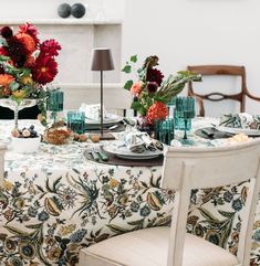 the table is set with flowers and candles