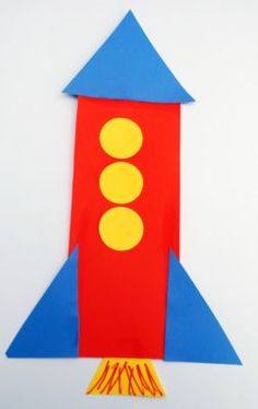 a paper rocket ship made to look like it is flying through the sky with yellow circles