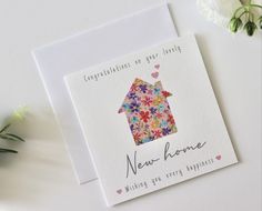 a greeting card with a house made out of flowers and the words congratulations to your home