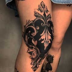 a woman's leg with tattoos on it and a pineapple tattoo on the side