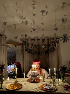 a birthday cake with lit candles on a table